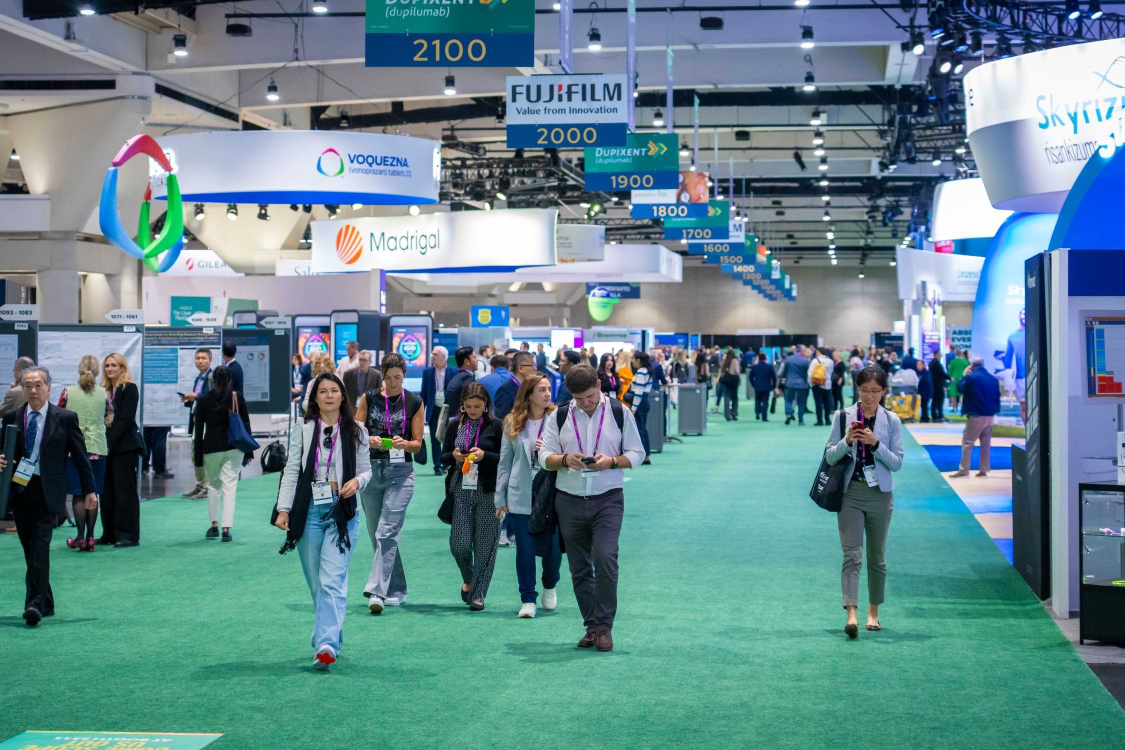 Convention attendees walking through an exhibit hall at the San Diego Convention Center